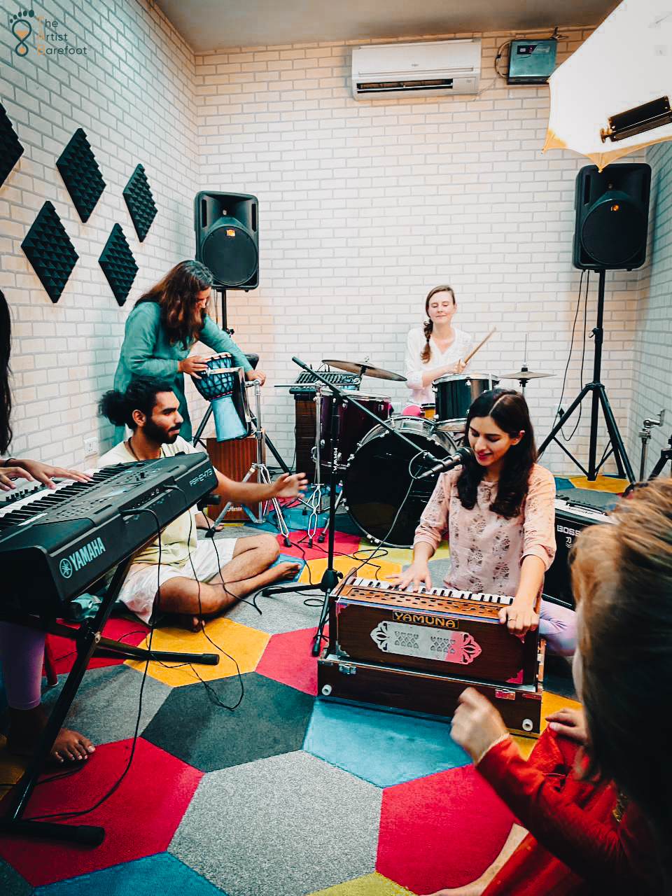 A student playing the drums during a lesson